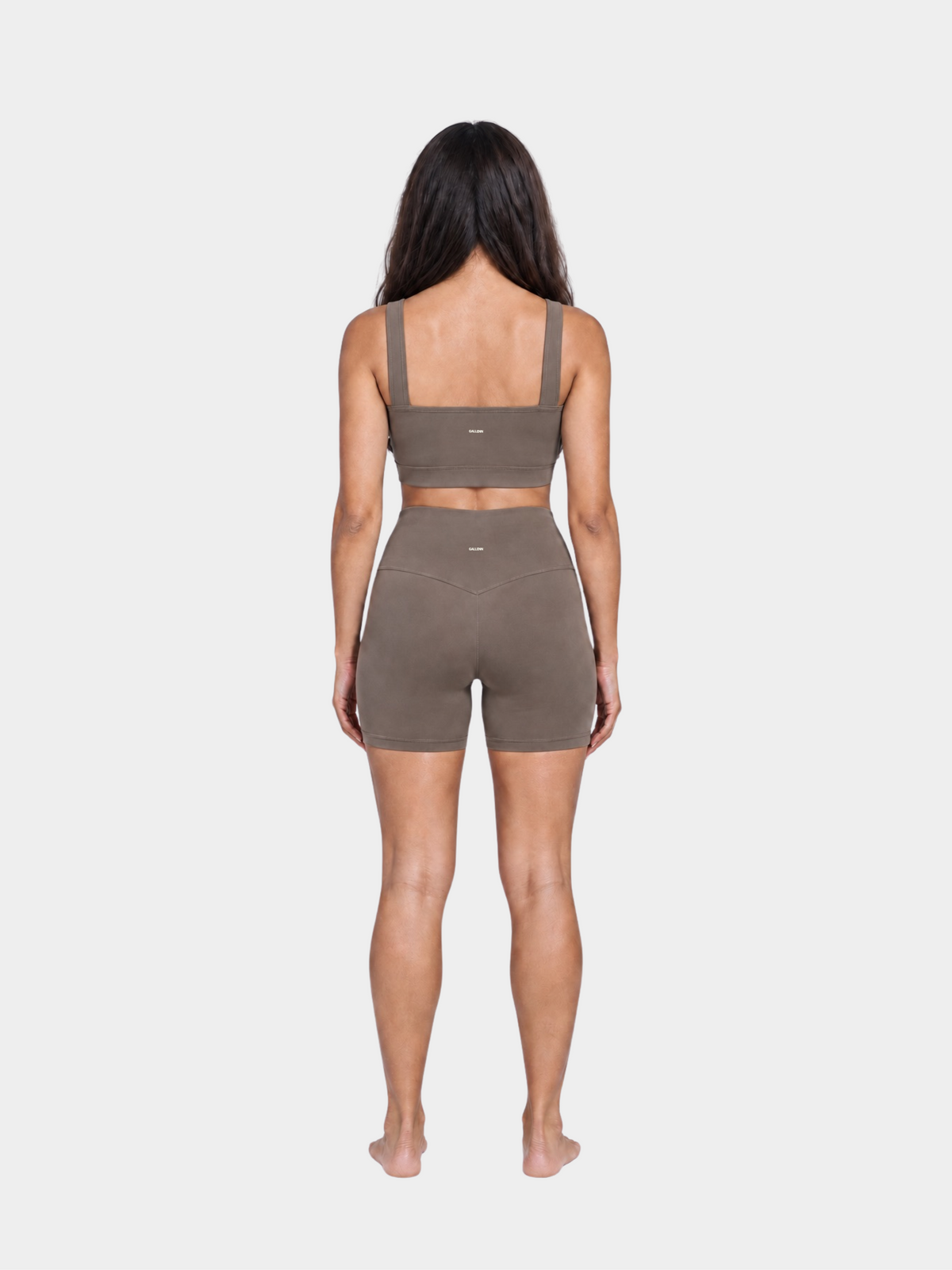 Woman wearing the Allure Short in Mocha by Gallenn – full back view