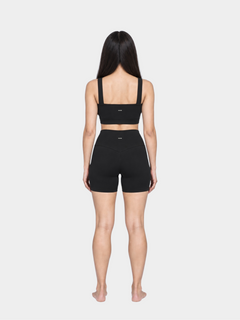 Woman wearing the Allure Short in Black by Gallenn – full back view