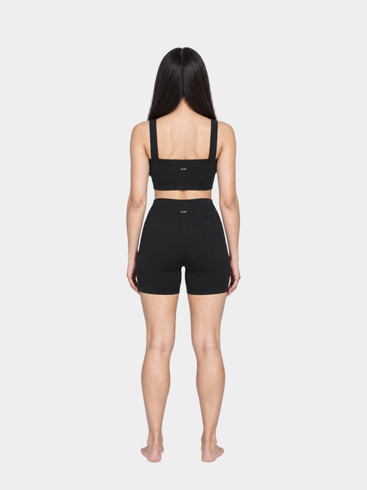 Woman wearing the Allure Short in Black by Gallenn – full back view