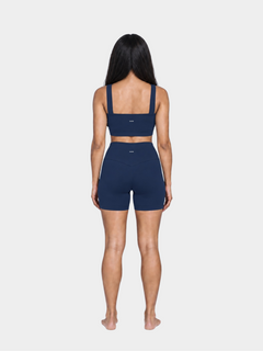 Woman wearing the Allure Short in Navy Blue by Gallenn – full back view