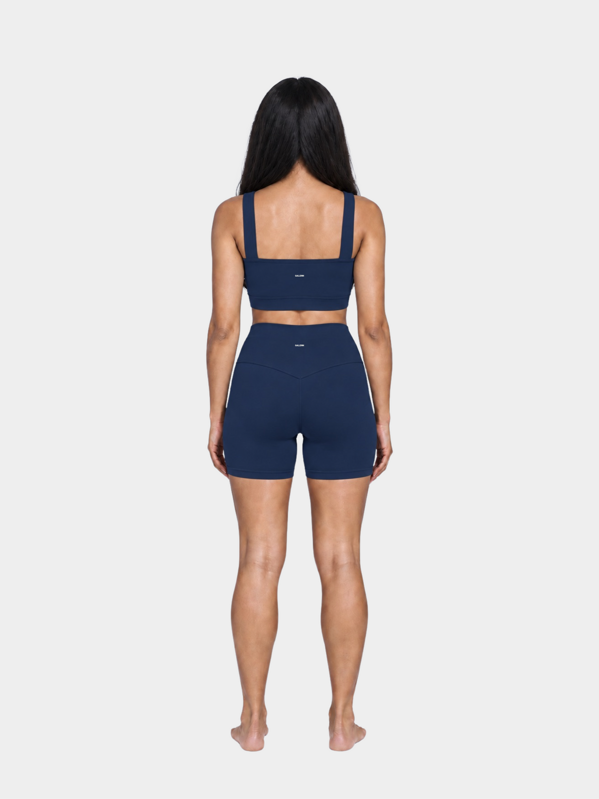Woman wearing the Allure Short in Navy Blue by Gallenn – full back view