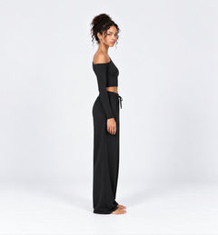 Woman wearing the Colette Top in Black with matching Colette Pants by Gallenn – side view
