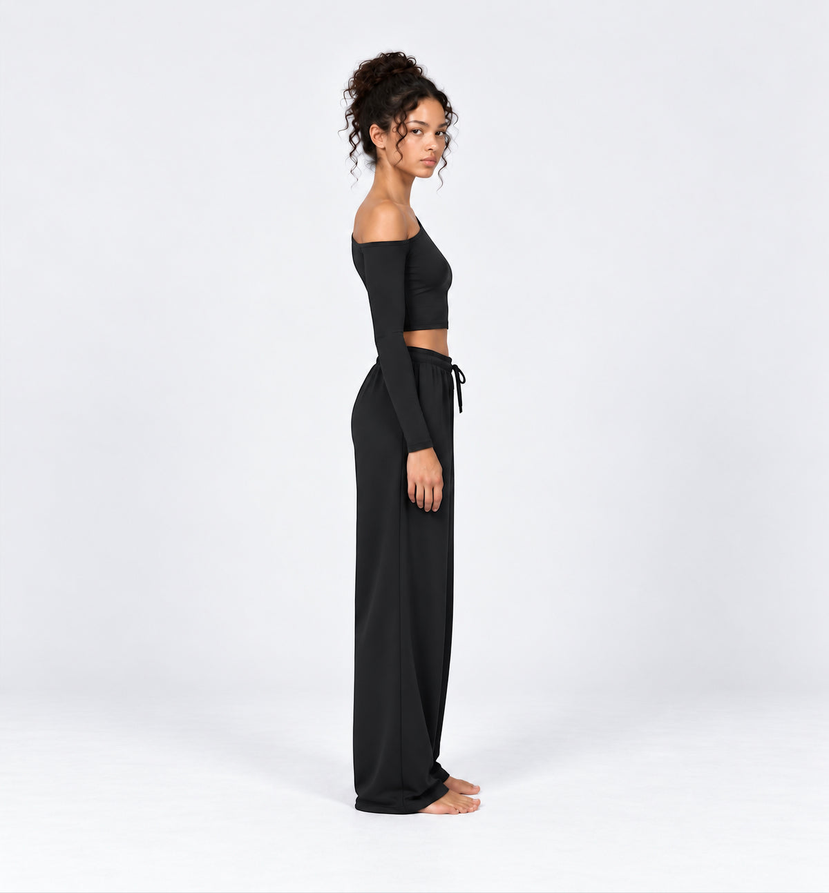 Woman wearing the Colette Top in Black with matching Colette Pants by Gallenn – side view