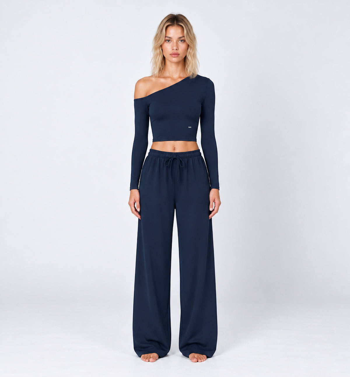 Woman wearing Colette Pants in Navy Blue with the matching Colette Top by Gallenn – front view