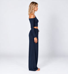 Woman wearing the Colette Top in Navy Blue with matching Colette Pants by Gallenn – side view