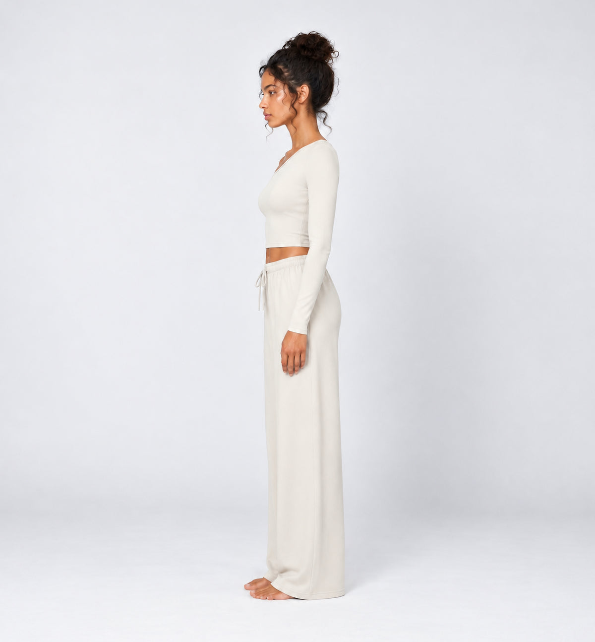 Woman wearing Colette Pants in Vanilla with the matching Colette Top by Gallenn – side view