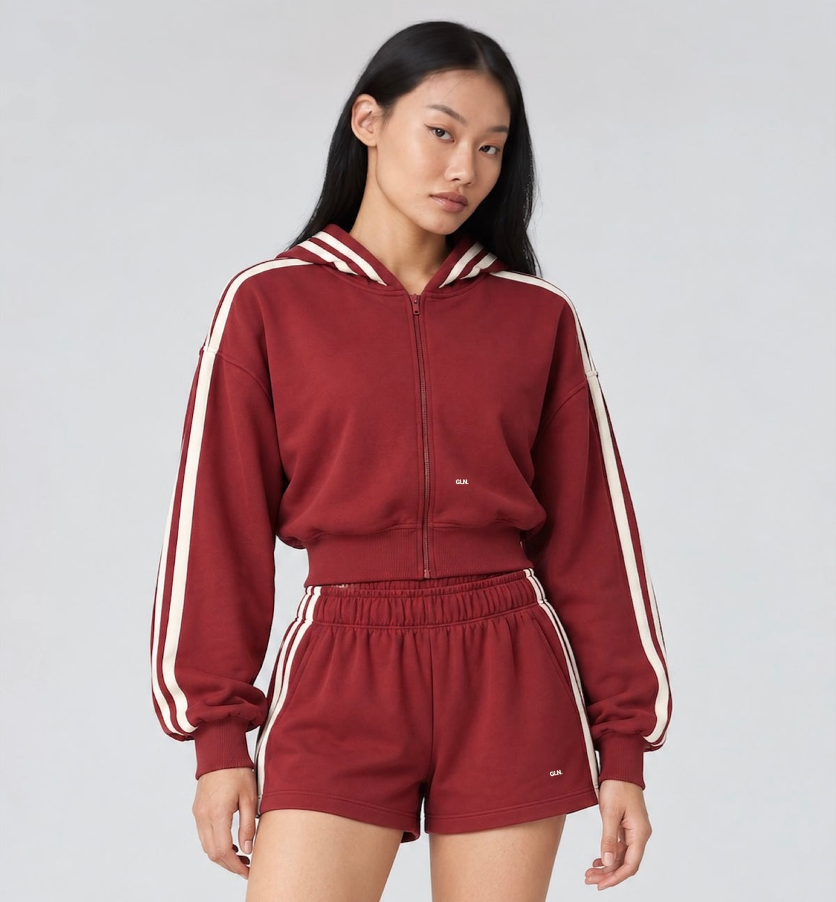 The Weekender Zip-Up Hoodie in Burgundy by Gallenn – model front with cream contrast stripes