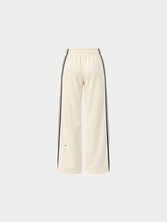 The Weekender Pants in Beige by Gallenn – product back view with wide legs and black side stripes