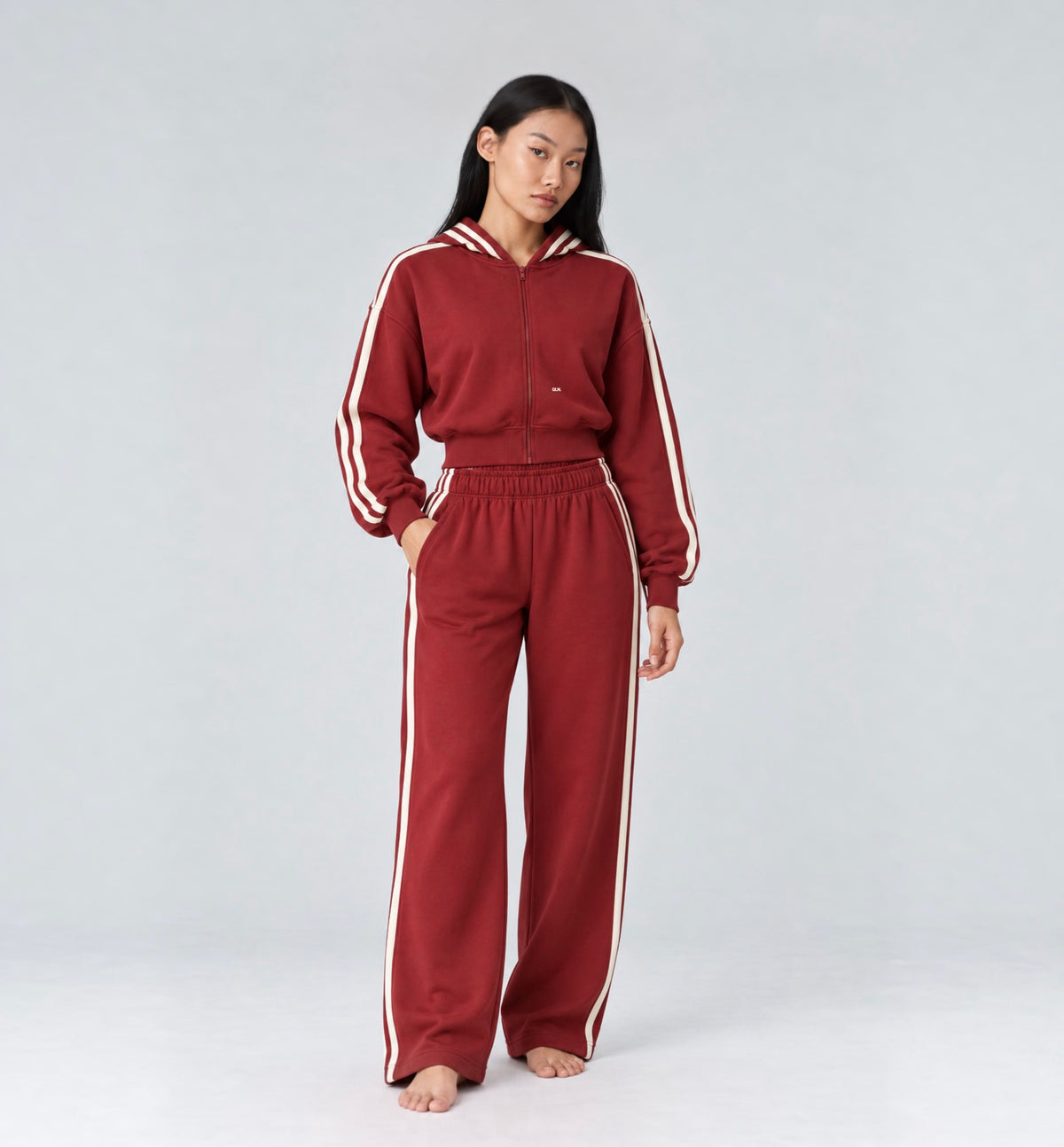 The Weekender Pants in Burgundy by Gallenn – model front view with wide legs and cream side stripes, worn with the matching hoodie