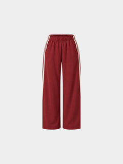 The Weekender Pants in Burgundy by Gallenn – product back view with wide legs and cream side stripes