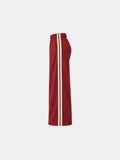 The Weekender Pants in Burgundy by Gallenn – product side view with wide legs and cream side stripes