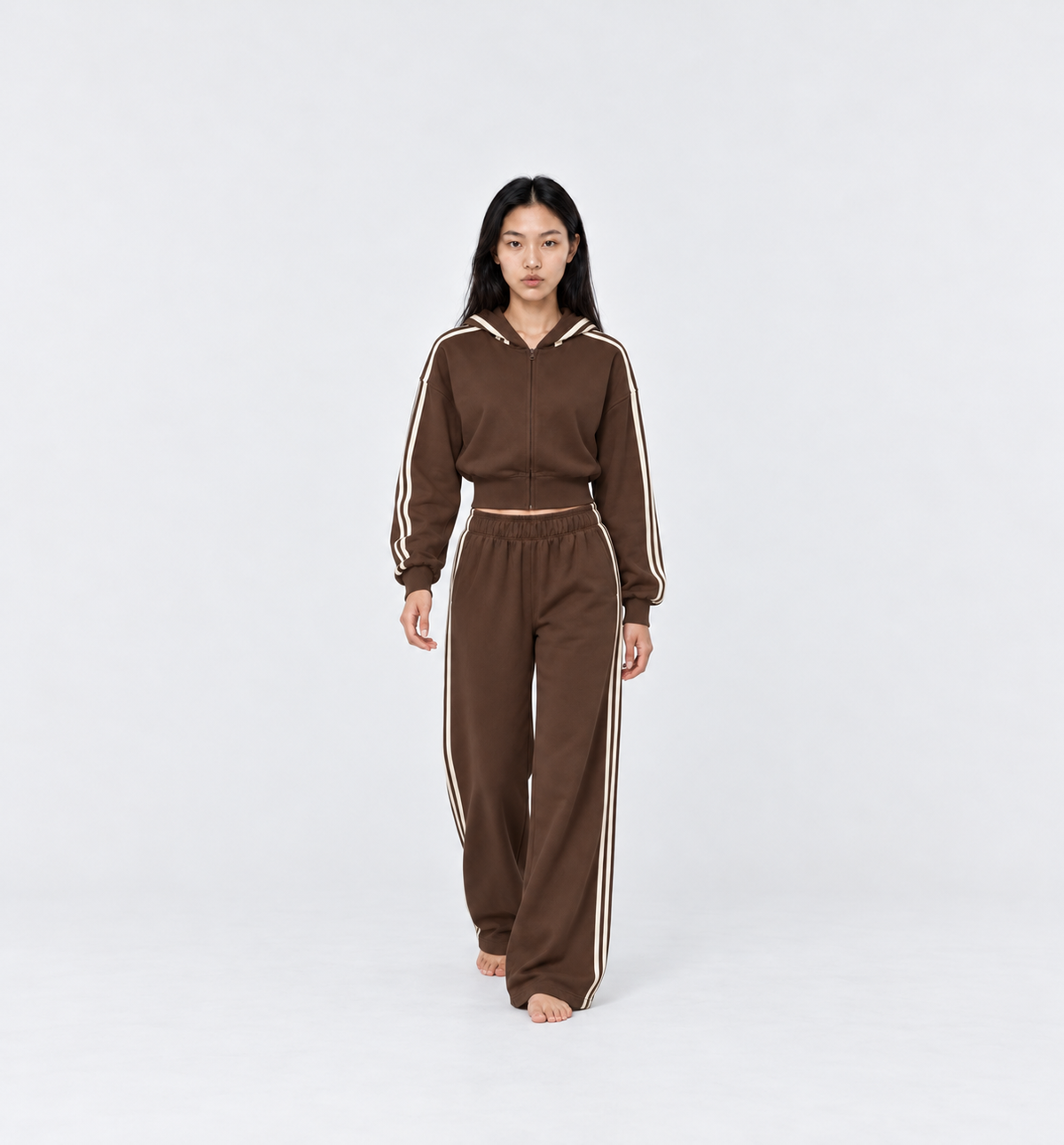 The Weekender Pants in Coffee by Gallenn – model front view, wide legs and cream side stripes, worn with the matching hoodie