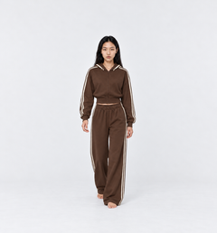 The Weekender Pants in Coffee by Gallenn – model front view, wide legs and cream side stripes, worn with the matching hoodie