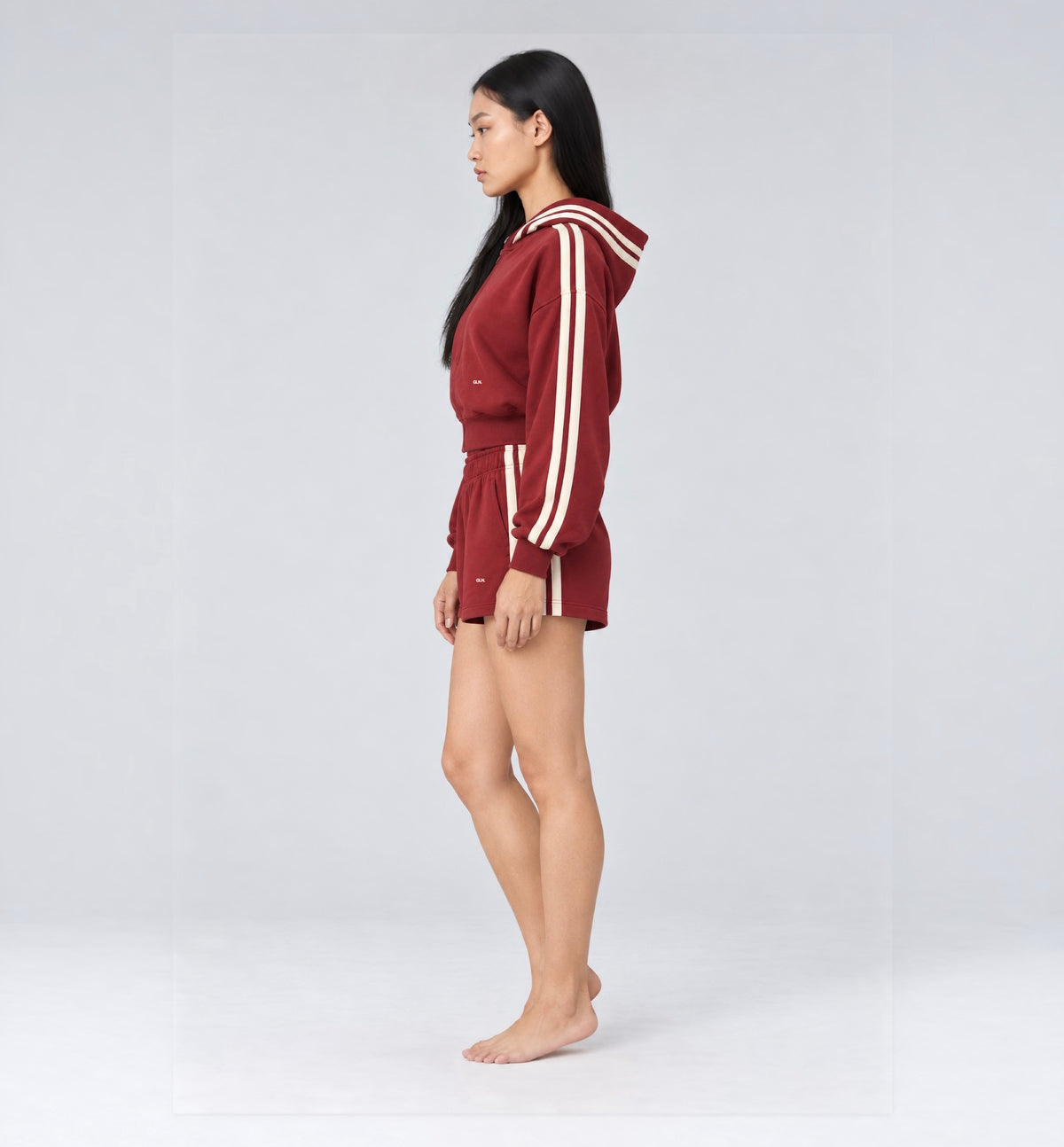 The Weekender Shorts in Burgundy by Gallenn – model side with matching zip-up hoodie